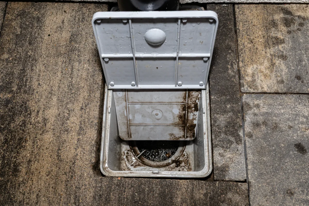 Opened rainwater settling trap with its inspection cover raised